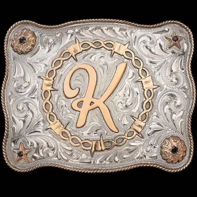 A custom initials belt buckle featuring a hand engraved silver base and barbed wire frame